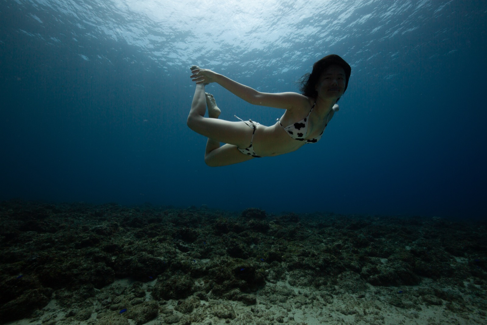 A smiling beginner in the shallow end at Divecube